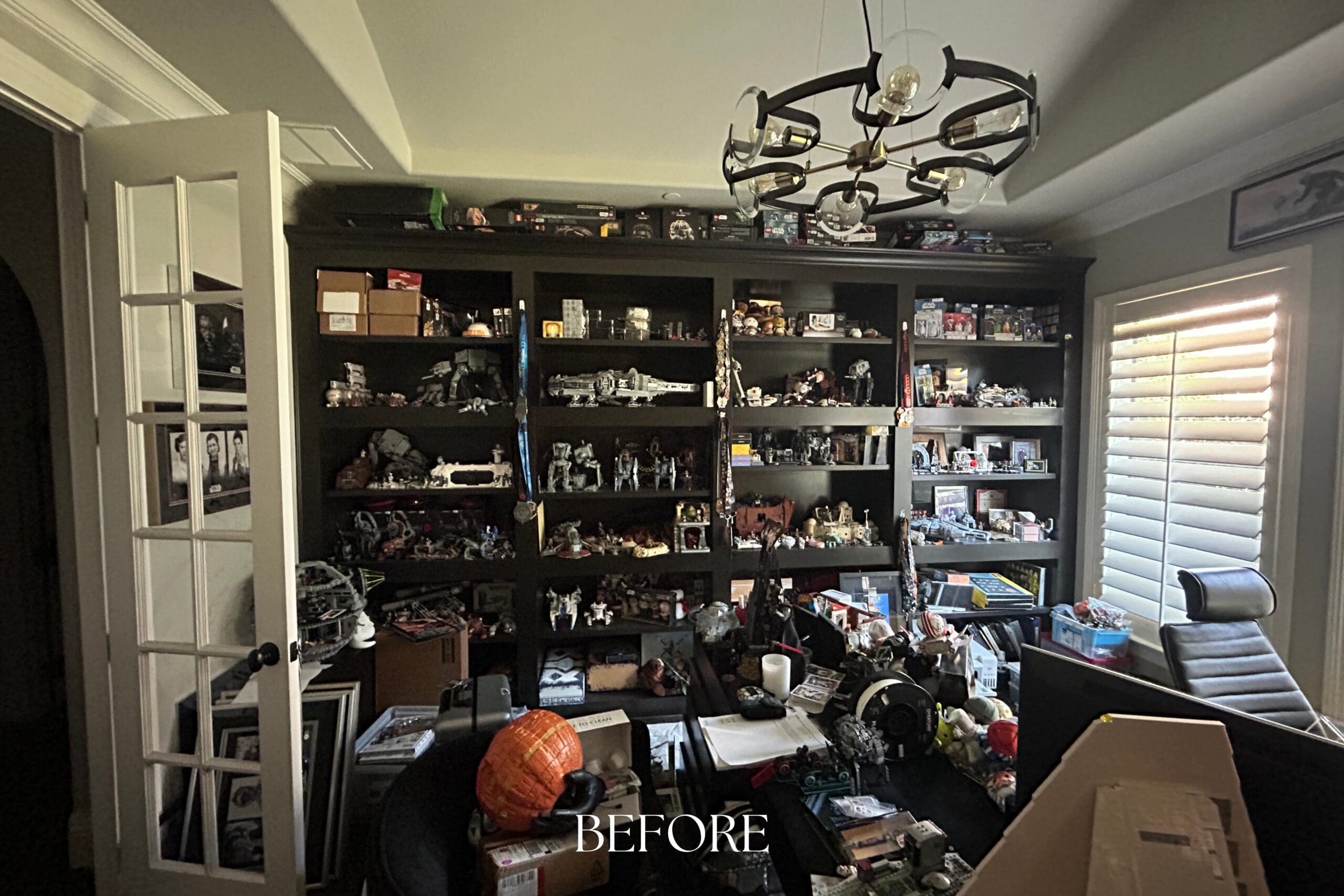 Overstuffed dark bookshelves before a home office remodel